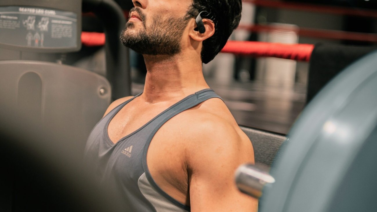 a man sitting on a bench in a gym