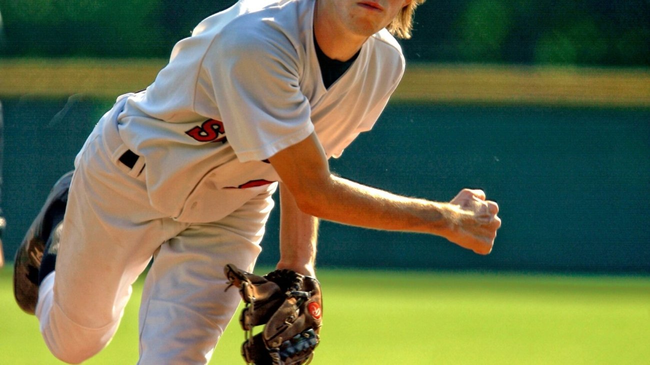 baseball pitcher throwing some fast ball pitch