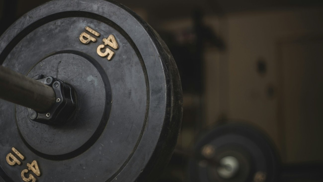 black and gray dumbbell on black surface