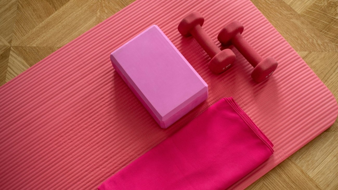 pink dumbbell on pink textile