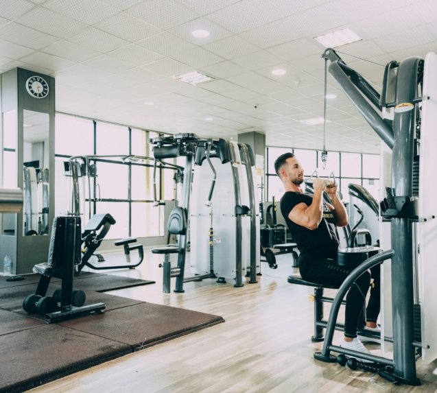 woman in black tank top and black pants exercising