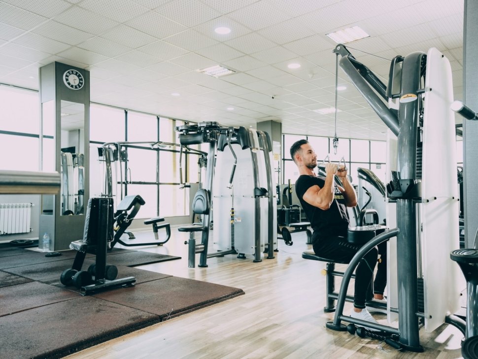 woman in black tank top and black pants exercising