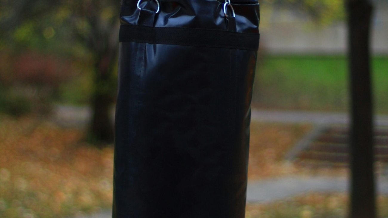 A heavy punching bag hangs outside.